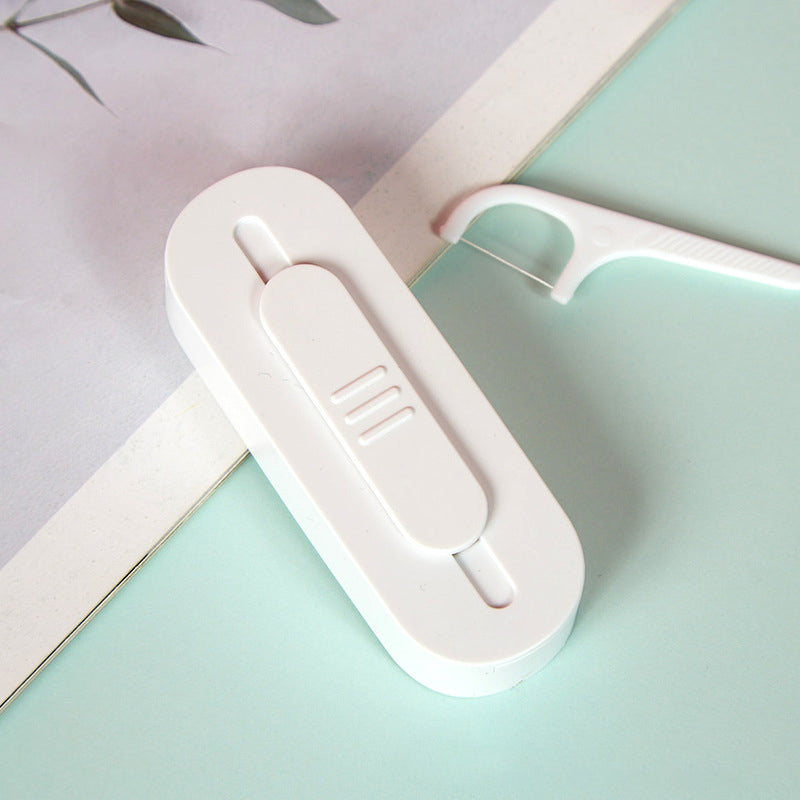 Bærbar to-vejs tandtrådsdispenser